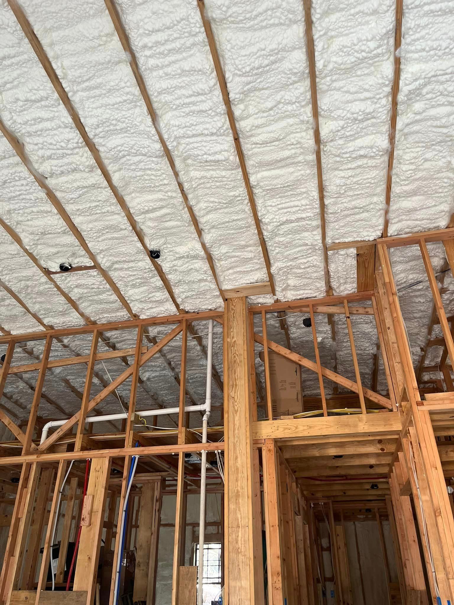 A house being built with spray foam insulation on the ceiling.