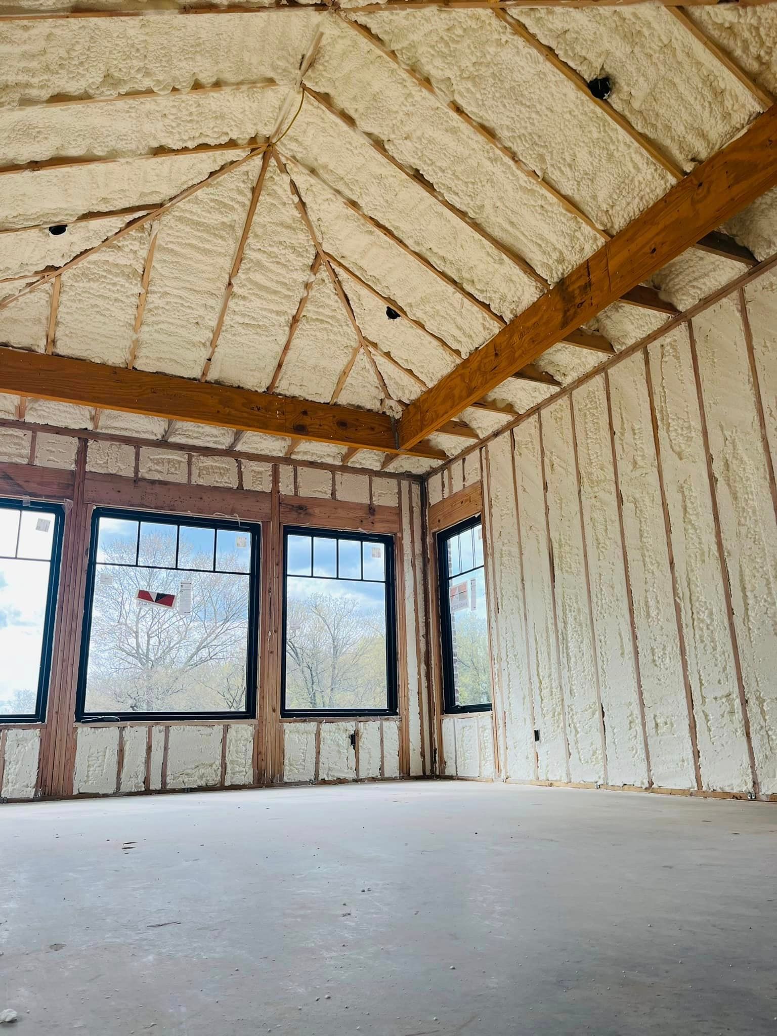 An empty room with insulation on the walls and ceiling.